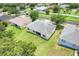 An aerial showcases the home's layout with a manicured lawn and neighboring properties at 2745 Shearwater St, Clermont, FL 34711
