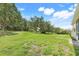 Spacious backyard featuring a lush lawn, mature trees, and ample room for outdoor activities at 2745 Shearwater St, Clermont, FL 34711