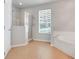 Bathroom featuring a glass shower, soaking tub, and a window at 2745 Shearwater St, Clermont, FL 34711