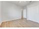 Bedroom with wood-look floors, ceiling fan, and double door closet at 2745 Shearwater St, Clermont, FL 34711