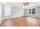 Bedroom with tray ceiling, ceiling fan, wood-look flooring and large windows at 2745 Shearwater St, Clermont, FL 34711