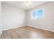 Bright bedroom featuring a ceiling fan, window and light wood-look flooring at 2745 Shearwater St, Clermont, FL 34711