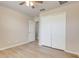 Bright bedroom featuring a ceiling fan, closet and light wood-look flooring at 2745 Shearwater St, Clermont, FL 34711