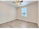 Comfortable bedroom featuring a ceiling fan, window and light wood-look flooring at 2745 Shearwater St, Clermont, FL 34711