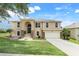 Charming two-story home featuring stone accents, a manicured lawn, and a welcoming two-car garage at 2745 Shearwater St, Clermont, FL 34711