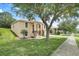 Inviting home exterior with well-kept lawn and mature trees, offering great curb appeal at 2745 Shearwater St, Clermont, FL 34711