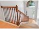 Inviting foyer with wood railing staircase and bright natural light from transom window at 2745 Shearwater St, Clermont, FL 34711