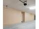 Spacious garage featuring a garage door and concrete flooring at 2745 Shearwater St, Clermont, FL 34711