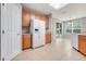 Bright kitchen with stainless steel refrigerator and access to a dining area and back yard at 2745 Shearwater St, Clermont, FL 34711