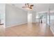 Spacious living room with tile flooring, ceiling fan, and large window for natural light at 2745 Shearwater St, Clermont, FL 34711