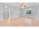 Open living room featuring tile flooring and ample natural light from a large window at 2745 Shearwater St, Clermont, FL 34711