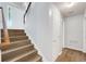 Well-lit staircase featuring wood-look steps and a white banister at 2745 Shearwater St, Clermont, FL 34711