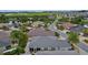 This aerial shot shows the neighborhood and a beautiful home near a pond at 2987 Kramer Ct, The Villages, FL 32163