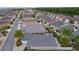Expansive aerial view captures a peaceful neighborhood with well-spaced houses, palm trees and lush greenery at 2987 Kramer Ct, The Villages, FL 32163