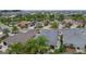 An aerial view of a well-planned neighborhood featuring beautiful homes, manicured lawns, and a scenic pond at 2987 Kramer Ct, The Villages, FL 32163