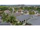 A beautiful aerial view of a residential neighborhood with well-maintained homes and lush landscaping near a pond at 2987 Kramer Ct, The Villages, FL 32163