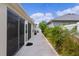 Outdoor view of a backyard featuring a patio, lush greenery, and meticulous landscaping at 2987 Kramer Ct, The Villages, FL 32163