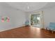 Bright bedroom with wood floors, light colored walls, a ceiling fan and sliding glass doors at 2987 Kramer Ct, The Villages, FL 32163