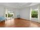 Bright bedroom with wood floors, light colored walls, a ceiling fan and sliding glass doors at 2987 Kramer Ct, The Villages, FL 32163