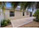This home's exterior shows off a concrete patio, beige paint, and a rock landscaping at 2987 Kramer Ct, The Villages, FL 32163