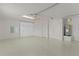 Spacious garage with epoxy flooring, storage cabinets, and well-lit interiors at 2987 Kramer Ct, The Villages, FL 32163