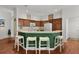 Kitchen features breakfast bar, wood cabinets, and white appliances at 2987 Kramer Ct, The Villages, FL 32163