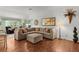 Bright living room featuring a large sectional sofa, hardwood floors, and stylish decor at 2987 Kramer Ct, The Villages, FL 32163