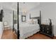 This main bedroom showcases tray ceilings, hardwood floors and a chandelier with lots of natural light at 2987 Kramer Ct, The Villages, FL 32163