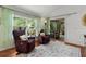 Cozy sitting room with comfortable chairs, a large window, and access to the patio at 2987 Kramer Ct, The Villages, FL 32163