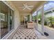 This bright sunroom features couches, multiple windows, and a ceiling fan with lots of natural light at 2987 Kramer Ct, The Villages, FL 32163