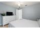 Bedroom featuring white comforter, white dresser, and a television at 3310 Osprey Hill St, Clermont, FL 34714