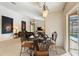 View of the dining area featuring decorative black chairs, tile flooring, and chandelier at 3310 Osprey Hill St, Clermont, FL 34714