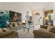 Bright living room with neutral-toned furniture, large windows, and a view into the entry way at 3310 Osprey Hill St, Clermont, FL 34714