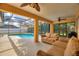 Enclosed patio with a view of a pool and landscaping at 3310 Osprey Hill St, Clermont, FL 34714