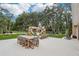 Spacious backyard featuring a dining area, outdoor seating, and a play area, perfect for entertaining and relaxation at 33943 E Lake Joanna Dr, Eustis, FL 32736