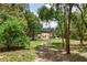Secluded backyard featuring a lawn and surrounded by a canopy of mature trees at 33943 E Lake Joanna Dr, Eustis, FL 32736