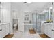 Bright bathroom featuring double vanities, soaking tub, and glass-enclosed shower at 33943 E Lake Joanna Dr, Eustis, FL 32736