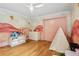 This bedroom offers hardwood floors, built-in storage, and charming decor at 33943 E Lake Joanna Dr, Eustis, FL 32736