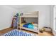 ' bedroom with bunk beds, a playful rug, and natural light from a large window at 33943 E Lake Joanna Dr, Eustis, FL 32736