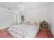 Bright bedroom with a ceiling fan, wood floor, and pink rug under the bed at 33943 E Lake Joanna Dr, Eustis, FL 32736