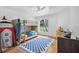 ' bedroom with bunk beds, wood floors, and a big window overlooking the yard at 33943 E Lake Joanna Dr, Eustis, FL 32736