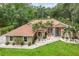 Charming single-story home with lush landscaping, featuring manicured lawn and mature trees, nestled in a serene setting at 33943 E Lake Joanna Dr, Eustis, FL 32736