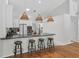 Modern kitchen featuring white cabinetry, granite countertops, stainless steel appliances, and a breakfast bar at 33943 E Lake Joanna Dr, Eustis, FL 32736