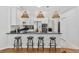 Charming kitchen featuring white cabinets, granite countertops, and a breakfast bar with stylish stools at 33943 E Lake Joanna Dr, Eustis, FL 32736