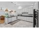 Bright kitchen with white cabinets, granite counters, and stainless appliances, open to the living room at 33943 E Lake Joanna Dr, Eustis, FL 32736