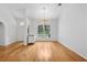 Bright living room featuring hardwood floors and an elegant chandelier at 33943 E Lake Joanna Dr, Eustis, FL 32736