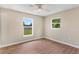 Bright bedroom featuring hardwood floors, neutral walls and two windows at 4 Kristin Ln, Eustis, FL 32726