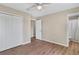 This bedroom has hardwood floors, a closet, and an entrance to the bathroom at 4 Kristin Ln, Eustis, FL 32726