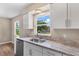 Kitchen showcasing white cabinets, granite countertops, stainless steel dishwasher and ample natural light at 4 Kristin Ln, Eustis, FL 32726
