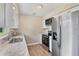 Bright kitchen featuring white cabinetry, stainless steel appliances, and granite countertops at 4 Kristin Ln, Eustis, FL 32726